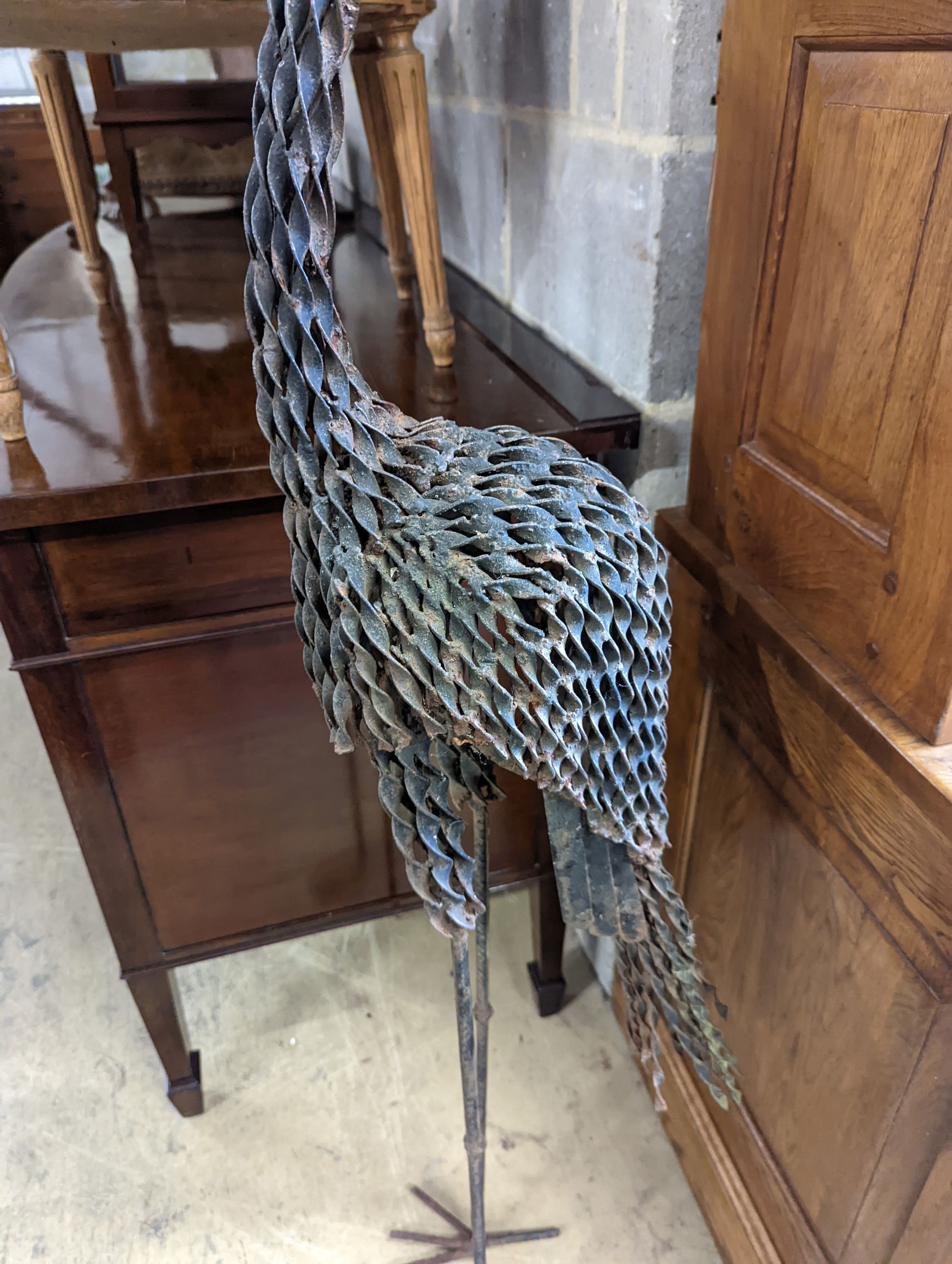 A wrought iron peacock garden ornament, height 170cm